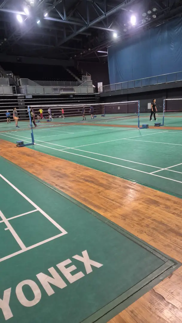 Yonex mats over a wooden floor