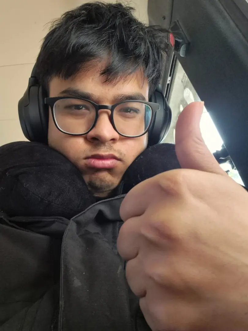 Bus selfie with headphones and neck pillow