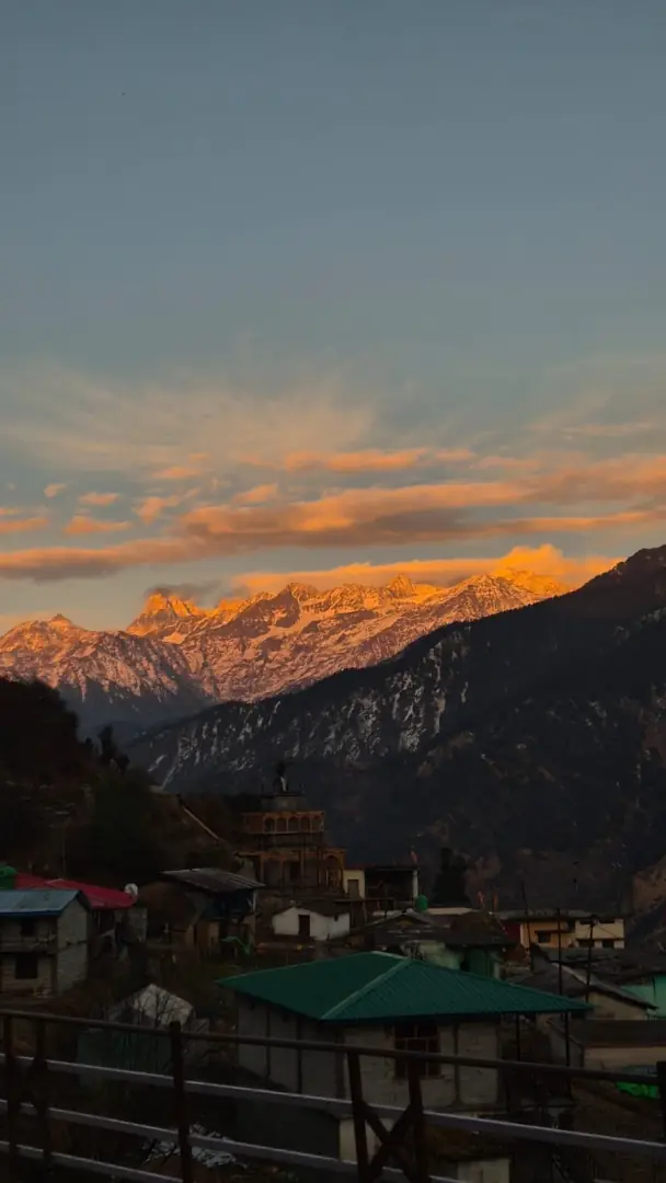 Raithal village at sunset with golden peaks